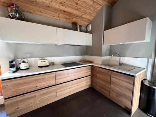 une cuisine avec des armoires en bois et un comptoir dans l'établissement Résidence Les Terrasses De Vars Ste Marie - LES TERRASSES DE VARS SAINTE MARIE MAE-9941, à Vars