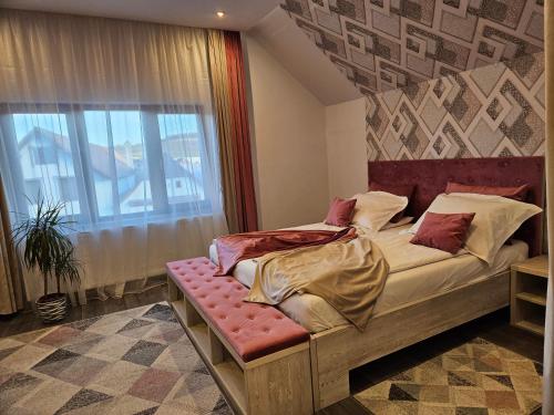 a bed in a room with a window and a bed sidx sidx sidx at Pensiunea Michael's House in Rupea