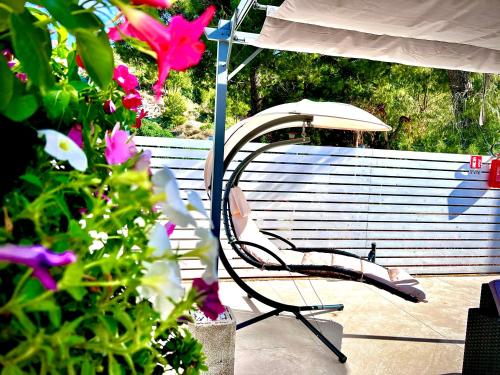 a chair sitting under an umbrella on a patio at Villa Latino in Vieste
