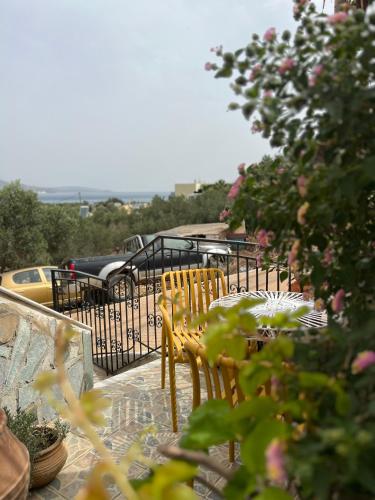 a table and chairs on a balcony with flowers at Ruby Apartment in Agios Nikolaos
