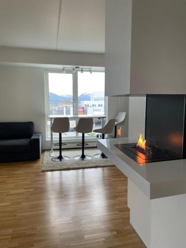 a living room with a fireplace and a table and chairs at Penthouse in Alta City in Alta