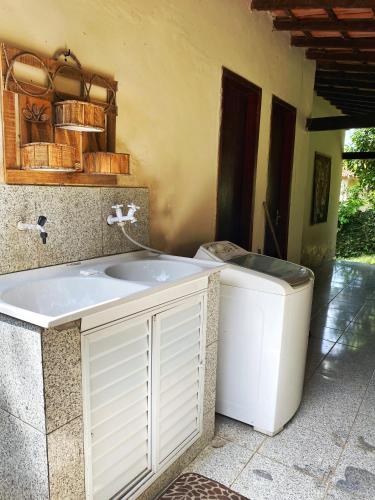 a bathroom with a sink and a trash can at Camping Green house in Saquarema