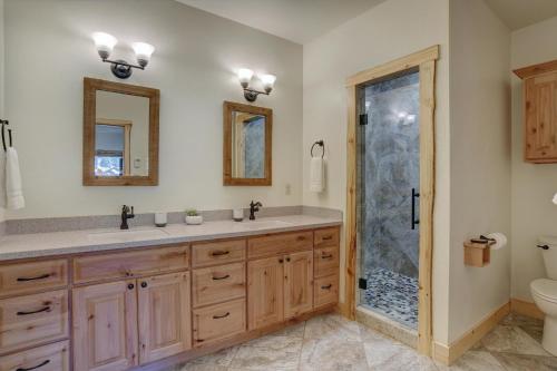 a bathroom with a double sink and a shower at MountainAire in South Fork, CO in South Fork