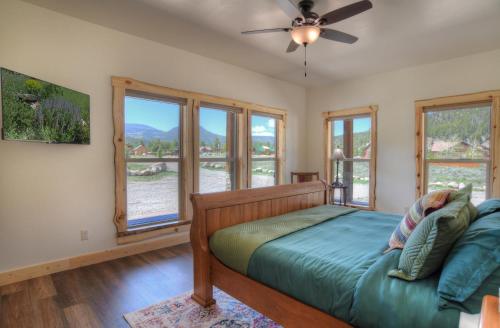 a bedroom with a bed and windows at MountainAire in South Fork, CO in South Fork