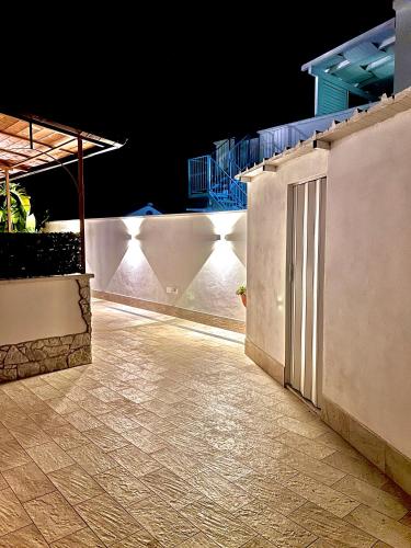 a white wall with a door on it at night at Villa Latino in Vieste
