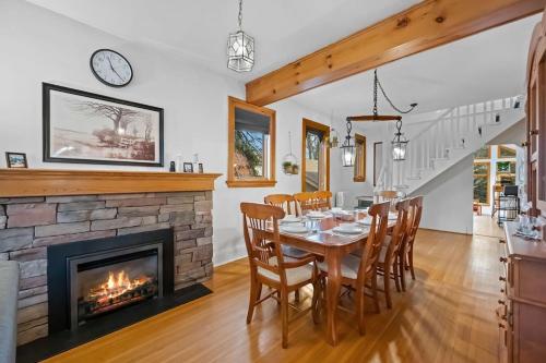 a dining room with a fireplace and a table and chairs at Picturesque & Serene Gem in Port Credit - Steps to Lake - Backyard in Mississauga