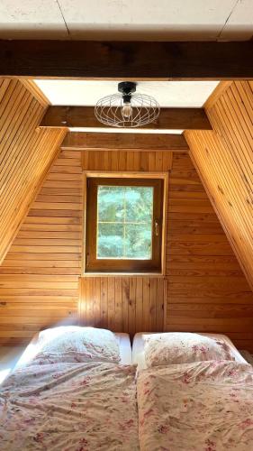 a bedroom with a bed in a room with a window at DOM LAS - natura, relaks, jacuzzi. in Mianów