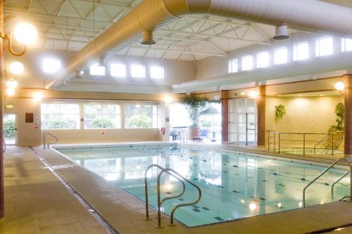 a large swimming pool in a large building at Greenhills Hotel Limerick in Limerick