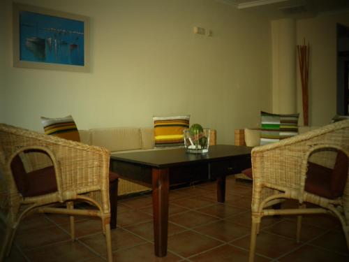 a living room with a table and a couch at Hostal Albacar in Melenara