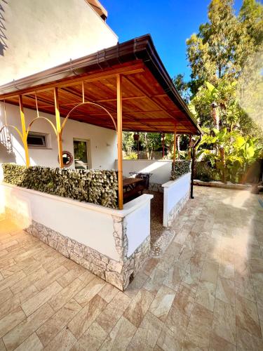 an outdoor bar with a wooden pavilion on a patio at Villa Latino in Vieste