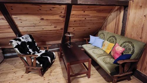 a living room with a couch and a chair at Roubenka Mia Jizerské hory in Tanvald