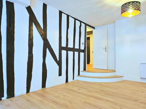 a hallway with a wall with a painting of trees on it at La Dame Blanche - Appartement hypercentre historique - Parking privé in Bourges
