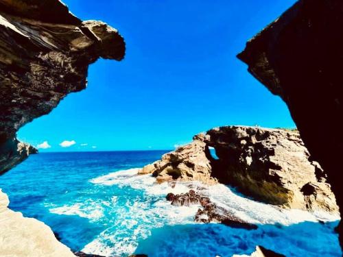 a view of the ocean from a rocky beach at La Colina House in Santana