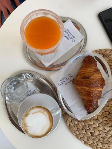 a table with a cup of coffee and a plate of food at B&B Casa Prencipe in Mattinata