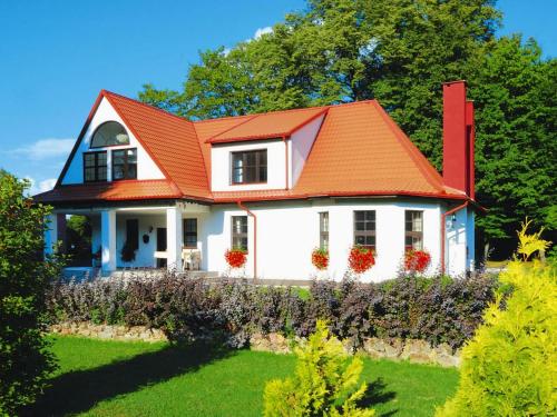 a white house with an orange roof at Villa in Kr g near Knight's Castle in Pollnow