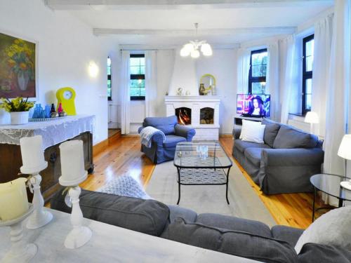 a living room with a couch and a fireplace at Villa in Kr g near Knight's Castle in Pollnow