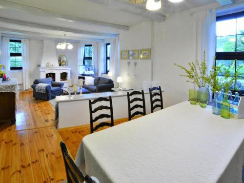 a kitchen and living room with a table and chairs at Villa in Kr g near Knight's Castle in Pollnow
