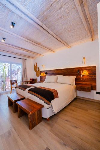 a large bedroom with a large bed and a table at Casa Solcor Boutique Bed & Breakfast in San Pedro de Atacama