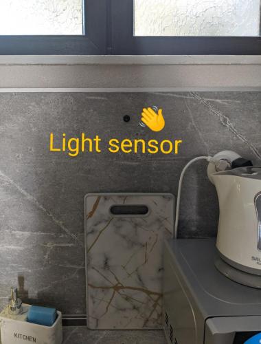 a light sensor sign on the wall of a kitchen at Emanuela Sea And Luxury in Kavala