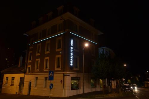 a building with a lit up sign on it at night at Beausite in Lausanne