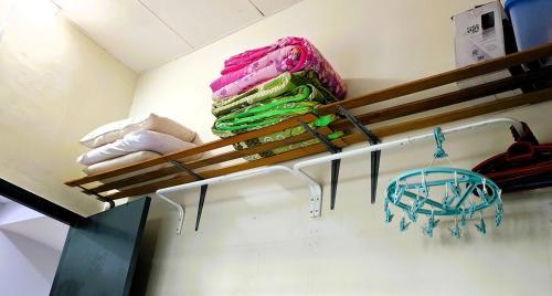 a shelf with towels on it in a room at CozyRizqy Homestay at Kebun Baru - 3R2B in Jenjarum