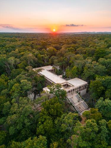 an aerial view of a building in the middle of a forest at Boca de Agua Bacalar in Bacalar