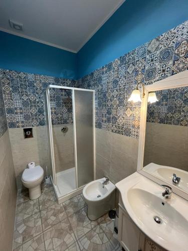 a bathroom with a shower and a toilet and a sink at Domus Arco Romano in Itri