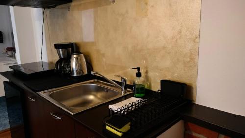 a kitchen counter with a sink and a keyboard at Nexus in Miercurea-Ciuc