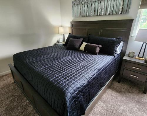 a bedroom with a large bed with a wooden headboard at bp1 Sunny Sunny in Beavercreek