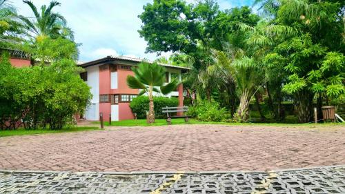 a brick road in front of a house at Apartamento Reserva Time Antube Praia do Forte in Mata de Sao Joao