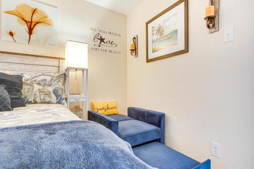 a bedroom with a bed and a blue chair at Wildwood Crest Condo with Pool and Beach Access! in Wildwood Crest