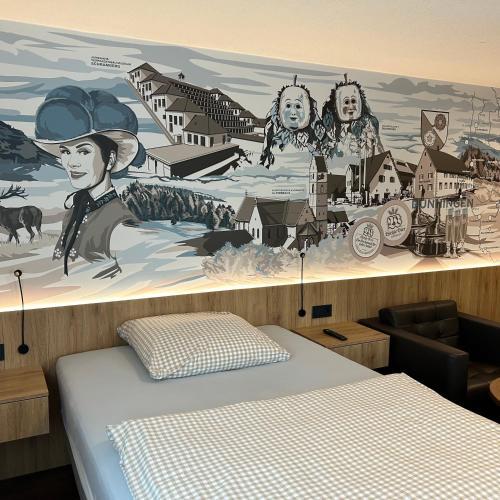a bedroom with a wall with a mural of a town at Braustube Wehle in Dunningen