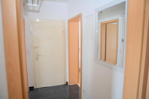 a bathroom with a mirror and a closet at Apartment Am Ring in Bochum