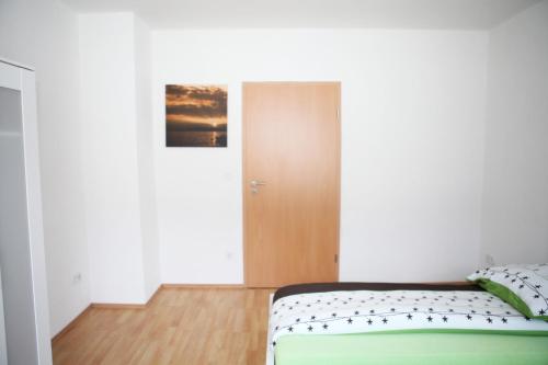 a small bedroom with a bed and a door at Apartment Am Ring in Bochum