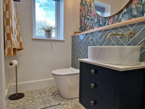 a bathroom with a sink and a toilet at The Little Baytree in Worle