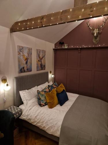 a bedroom with a bed with pillows on it at The Little Baytree in Worle