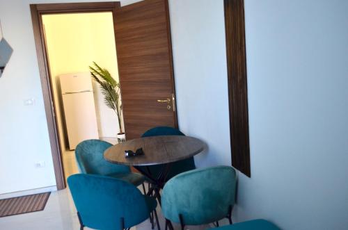 a meeting room with a table and blue chairs at Monolocale Casa Palma in Nardò