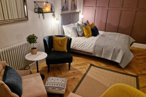 a living room with a bed and a chair at The Little Baytree in Worle