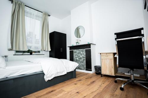 a bedroom with a bed and a desk and a chair at Chambre R1 avec salle de bain partagée près de l'hôpital de la Citadelle à Liège in Liège