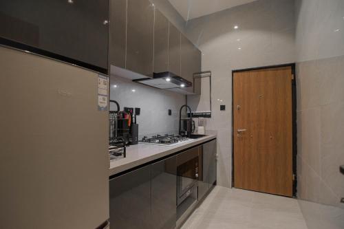 a kitchen with a sink and a stove top oven at One90 Apartment in Lagos