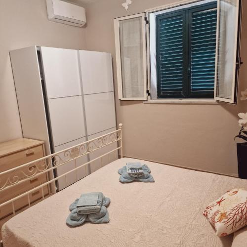 a bedroom with a bed and a refrigerator at Casa Geloso in Ustica