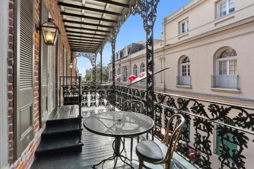 a patio with a table and chairs on a balcony at Place D'Armes Hotel in New Orleans