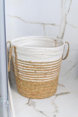 a basket sitting on a counter in a bathroom at Comfortable 3-Bedroom Maisonette Near the Sea in Mytilini