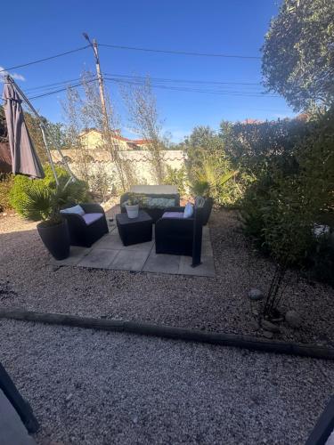 a patio with two couches and a table at La villa des oliviers in Sorède