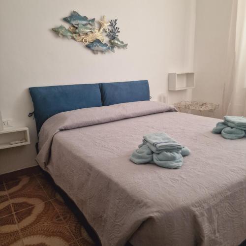 a bedroom with a bed with two towels on it at Casa Geloso in Ustica
