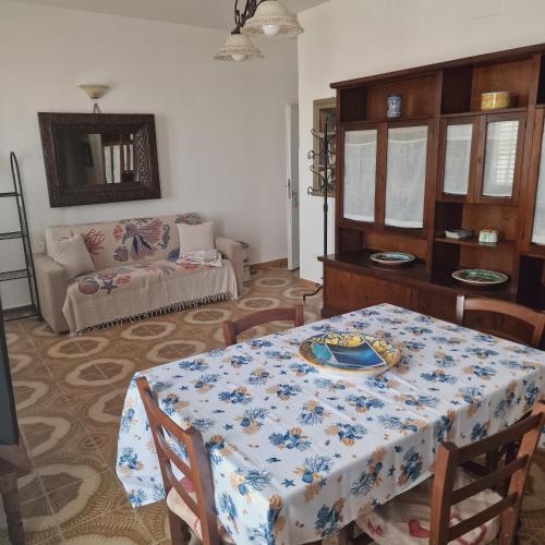 a living room with a table and a couch at Casa Geloso in Ustica