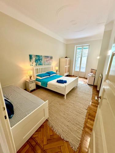 a bedroom with two beds and a rug at La Dolce Vita 5 Star Luxury Sanremo in Sanremo