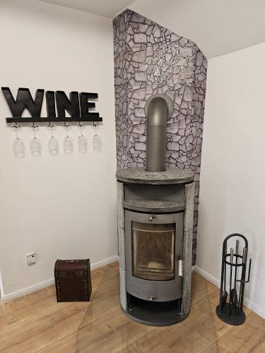 a fireplace in a room with a stone wall at Tautraum Suite mit Whirlpool und grünem Ausblick in Wilhelmshaven