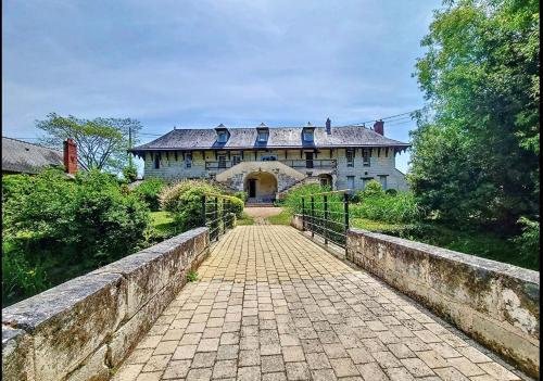 a large house with a walkway in front of it at Domaine Jeanne de Laval in La Bohalle