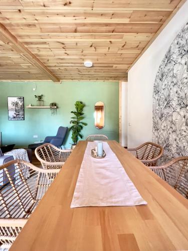 a large wooden table in a room with chairs at Hacienda la Yerbabuena in Cádiz
